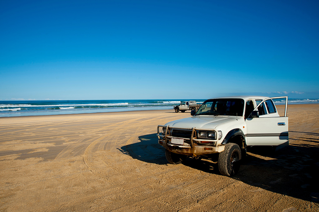 A 4WD driving along a beach